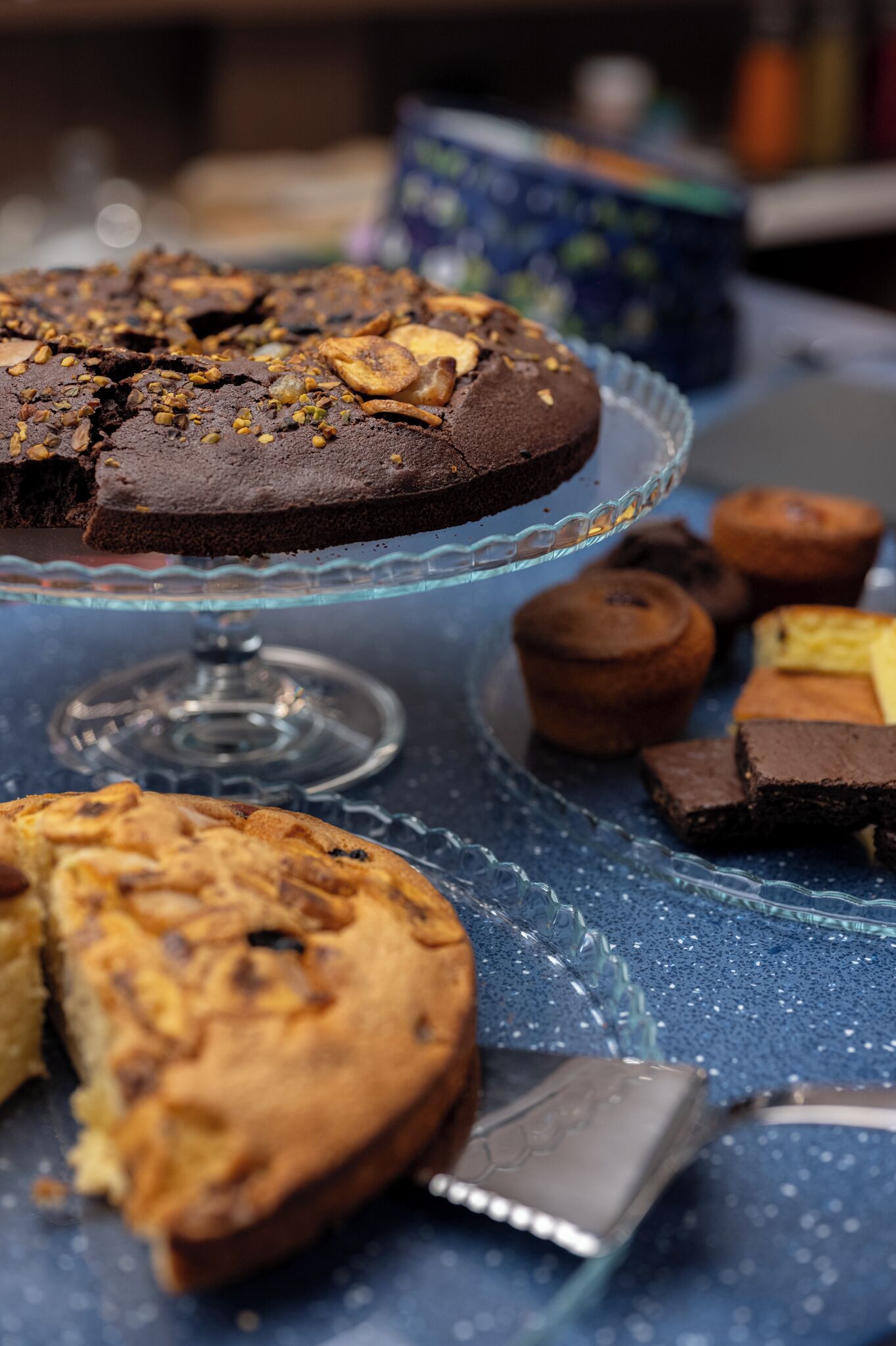 A dessert table with various baked goods, including a cake and muffins.