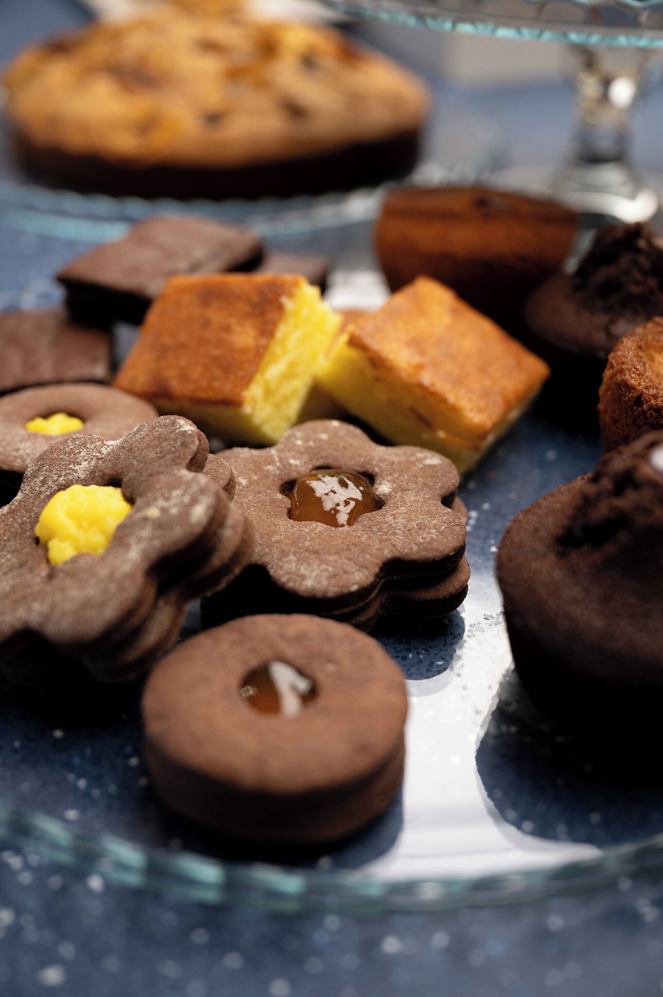 A variety of baked goods on a glass display stand.