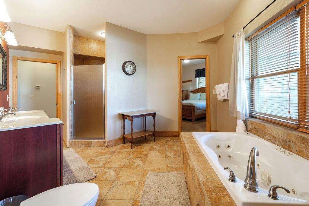 A bathroom with a bathtub, a sink, a toilet, and a shower.
