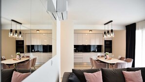 A modern living room with a sofa and a dining area with a table and chairs. - Apartment with rooftop pool A2, Bibinje (Bibinje)