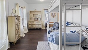 A bedroom with a bunk bed, a dresser, a desk, and a wardrobe. - Pet-friendly Historic 4BR Home in Illinois (Lynn Center)