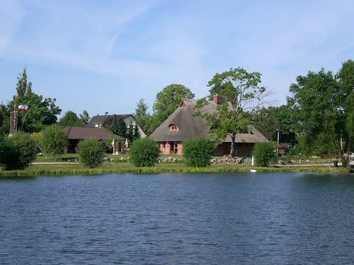 Vacation apartment directly at the fishing pond with parking lot and terrace