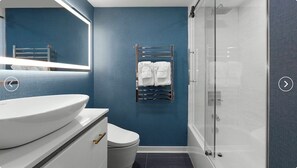 A modern bathroom with a large white sink, a toilet, a towel rack with two towels, and a glass shower enclosure. - Cozy 2-bedroom condo with AC in amazing Myrtle Beach (Myrtle Beach)