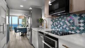 A modern kitchen with a large island, stainless steel appliances, and a unique tiled backsplash. - Cozy 2-bedroom condo with AC in amazing Myrtle Beach (Myrtle Beach)