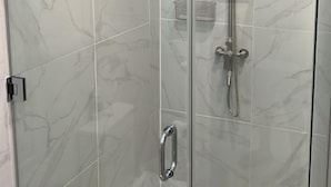 A glass-enclosed shower with a handheld showerhead and a wall-mounted faucet. - 3-bedroom and 2 bathroom house in pleasant and safe Victoria Gardens with AC (Diego Martin Regional Corporation)