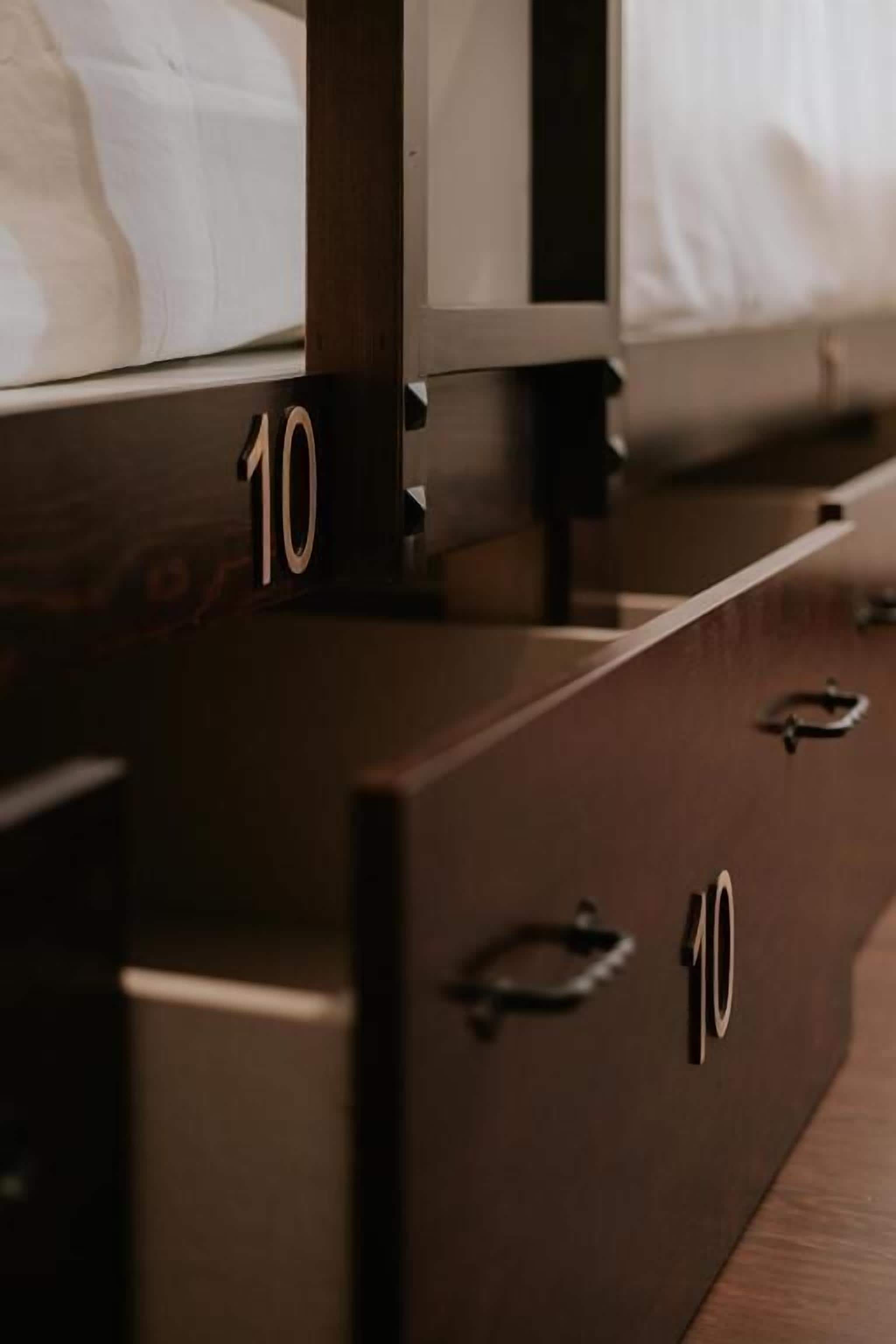 A wooden dresser with drawers marked with the number 10.