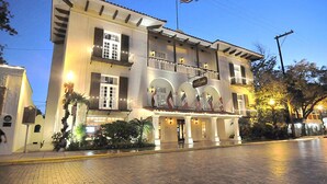 A hotel with a classic facade, multiple balconies, and a sign indicating a restaurant. - Spacious 3 King Suite with Pools, Grill & Bar Near Laredo Dining & Shops (Laredo)