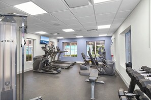 A gym with treadmills, elliptical machines, and dumbbells. - Coastal Retreat: Pool, Kayak, Beaches & Bikes (Jensen Beach)