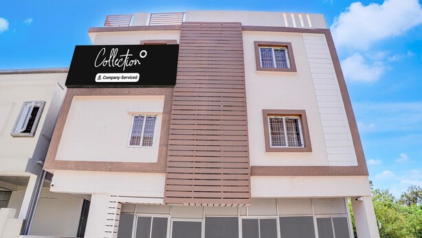 A multi-story building with a sign reading 'Collection Company-Serviced.' - Classic Havens Residency (Chengalpattu)