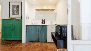 A compact kitchen with a microwave, coffee maker, and a small refrigerator. - Guesthost - Teatro Massimo Lovely Flat With Balconies (Palermo)