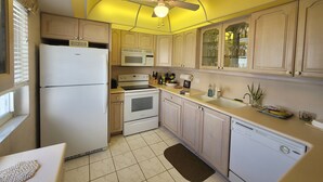 A compact kitchen with a refrigerator, microwave, stove, oven, and dishwasher. - CT 7344 Pond and Fountain View Condo - Welcome to Paradise (Fort Pierce)