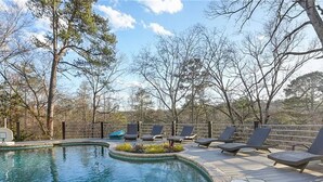 A swimming pool with lounge chairs and a wooden deck. - Luxury Mansion available with Pool, Gym and More - Perfect for entertaining (Atlanta)