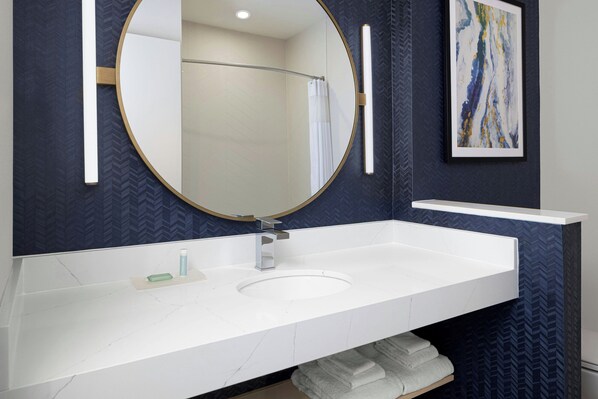 A bathroom with a large mirror, a white sink, and a towel rack. - Fairfield By Marriott Inn & Suites Athens Madison (Madison)