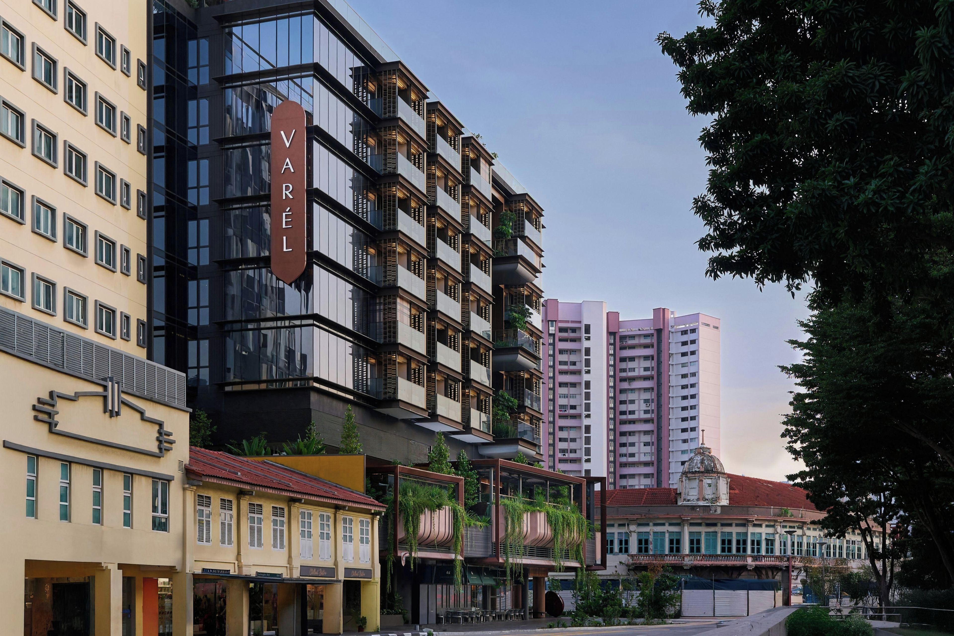 A multi-story hotel with a prominent 'VAREL' sign, featuring balconies and a modern architectural style.