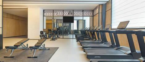 A gym with treadmills, benches, and weight machines.