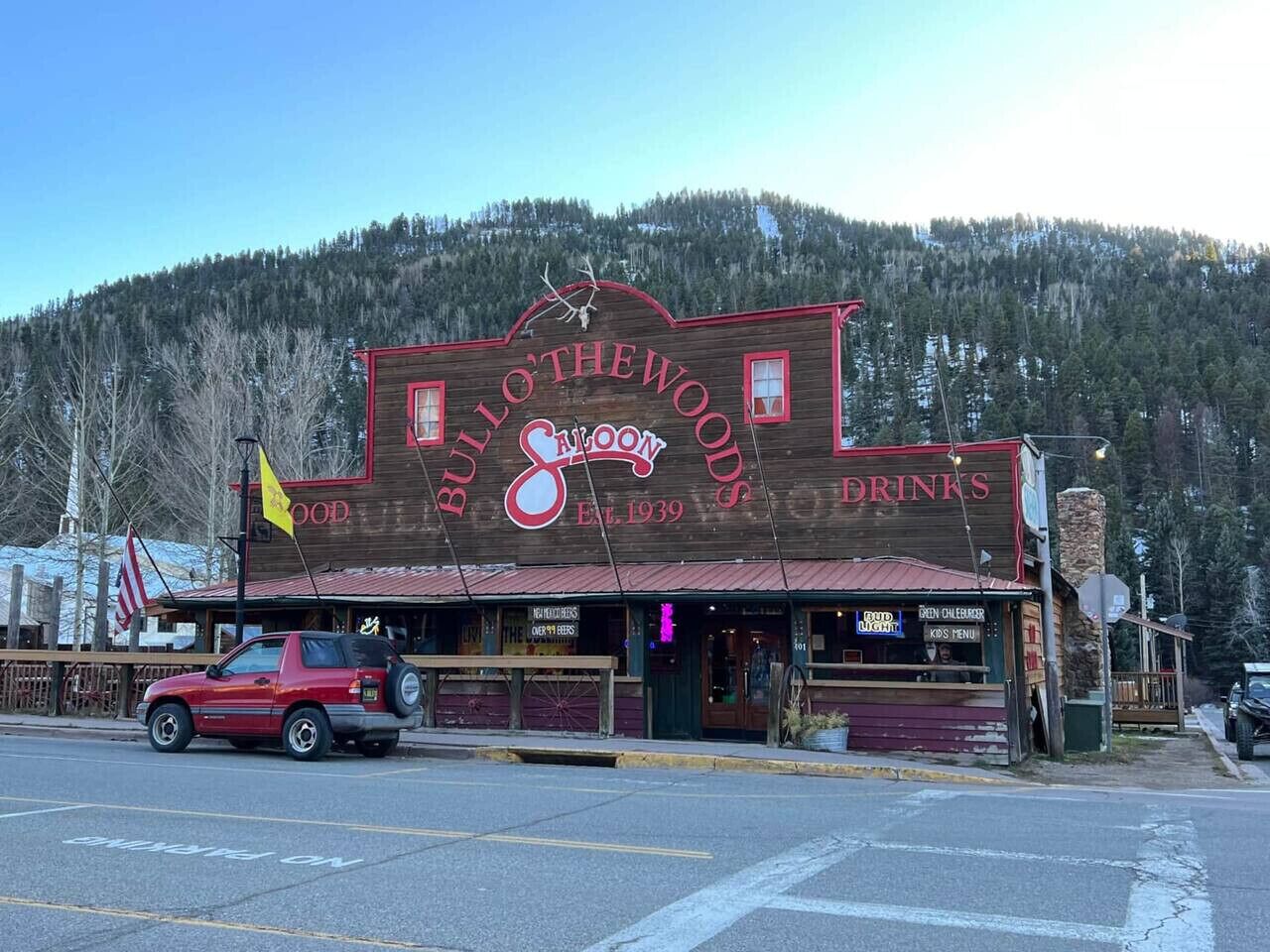 A wooden building with a sign reading "BULLSHEADS" and "Drinks" indicating a bar or restaurant.