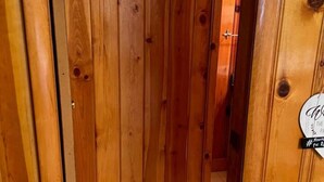 A wooden door with a metal handle and a circular sign with text. - Room 5 at Bellamy's Haus (Red River)