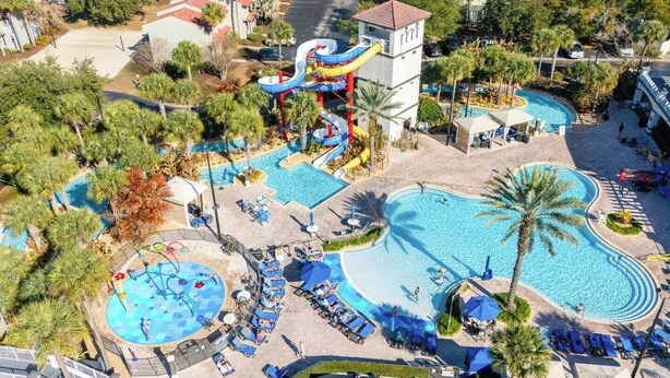 A resort with multiple swimming pools, a water park, and lounge areas with sunbeds. - Amazing Spider | Disney, Slides & River (Kissimmee)