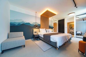 A modern hotel room with a bed, a seating area, a wall mural, and a bathroom visible through a glass door. - 5 stars Luxury Villa in Lopar on island Rab (LOPAR (RAB))