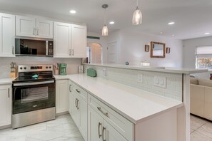 Coffee/tea maker, high chair, cookware/dishes/utensils, dining tables - Steps to Sand: Clearwater Family Home w/ Game Room (Clearwater)