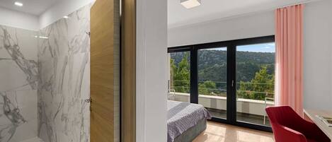 A modern bedroom with a large bed, a red chair, and a balcony with a view of the hills.