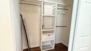 A walk-in closet with open shelving, a hanging rod, and a shoe rack. - Modern 3BR LA Home near Downtown LA, Perfect for Families and Large Groups (Los Angeles)
