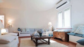 A living room with a sofa, a coffee table, and a lamp. - Villa Gioia | Tranquil Hideaway Beach Cottage (Pula)