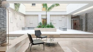 A modern interior with a seating area, a coffee table, and a plant.