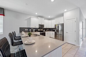 House, Multiple Bedrooms, Lanai, Courtyard View | Private kitchen | Full-size fridge, microwave, oven, stovetop - Nine Bedroom Vacation Home ChampionsGate (Davenport)