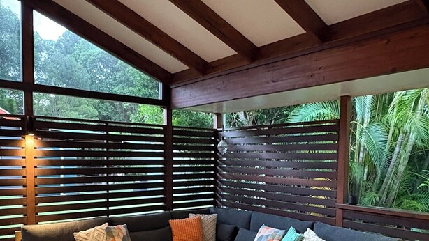 A modern living room with a sectional sofa, a coffee table, and a view of greenery through large windows. - Cowan Lodge Cowan Cowan (Cowan Cowan)