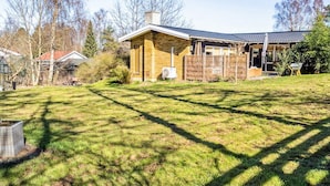 A house with a brick exterior, a fenced yard, and a covered porch.