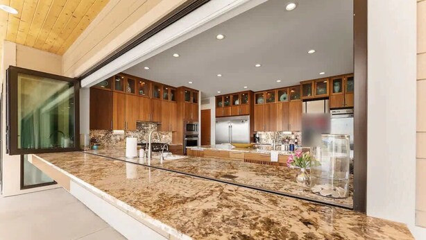 A modern kitchen with granite countertops, wooden cabinets, and stainless steel appliances. - Private beach with panoramic lake views (Entiat)