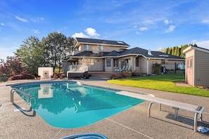 A residential property with a swimming pool, a covered patio, and a two-story house. - As the Chelan Valley sky transitions into twilight, take your place in the steam (Manson)