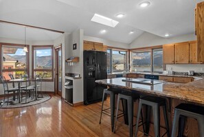 Prepare meals at this stunning kitchen island with sweeping mountain views and warm wood cabinetry, flowing seamlessly to your private outdoor dining area. - As the Chelan Valley sky transitions into twilight, take your place in the steam (Manson)