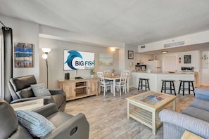 A living room with a sofa, coffee table, and a TV displaying 'BIG FISH Rentals.' - High Floor, 2BR, Pools, Ocean Views, Palace Resort (Myrtle Beach)
