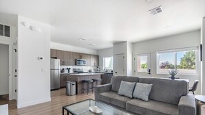 Eine moderne Wohnung mit Küche, Wohnbereich und Essplatz.