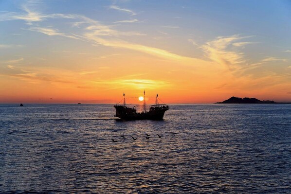 A boat on calm waters during sunset.