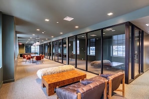 A modern office space with glass partitions, leather seating, and a wooden table. - Landing | Beautiful 1BD in Downtown Hartford (Hartford)