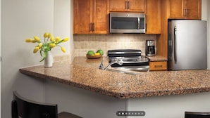 A kitchen with granite countertops, stainless steel appliances, and wooden cabinets. - Relaxing Marriott Shadow Ridge 2-bedroom resort in peaceful Palm Desert (Palm Desert)
