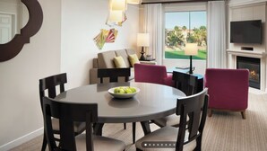 A hotel room with a dining area, a sofa, a TV, and a fireplace. - Relaxing Marriott Shadow Ridge 2-bedroom resort in peaceful Palm Desert (Palm Desert)