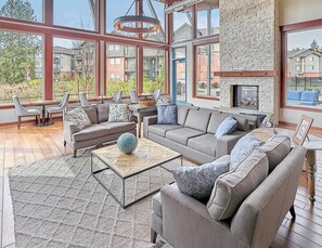 A spacious living room with a large sectional sofa, a coffee table, and a fireplace. - Landing | Amazing 1BD, Clubhouse, Pool (Marysville)
