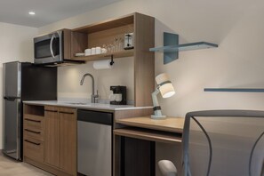 A modern kitchen with a built-in microwave, coffee maker, and a sink. - Home2 Suites By Hilton Pleasant Grove Provo North (Lindon)