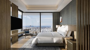 A modern hotel room with a large bed, a TV, a city view, and a wooden accent wall. - Conrad Nagoya (Nagoya)