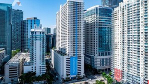 A high-rise urban hotel with multiple floors, a prominent blue vertical stripe, and a modern architectural design. - Sky-High Luxury 1BR with Brickell City & Bay Views (Miami)