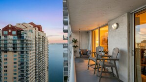 A balcony with a view of a high-rise building and a body of water. - Sky-High Luxury 1BR with Brickell City & Bay Views (Miami)