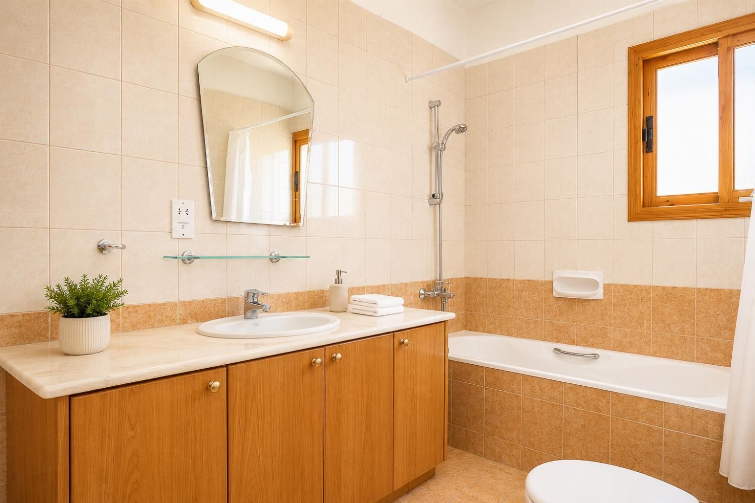 Kylpyhuone, jossa on pesuallas, peili, suihku ja wc.
