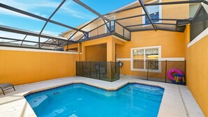 A swimming pool with a glass enclosure, a chair, and a window overlooking the pool. - Bright & Breezy Disney Escape | Pool | BBQ (Kissimmee)