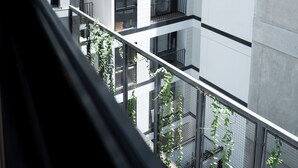 A multi-story residential building with balconies, large windows, and a view of greenery below. -  Miraflores Prime Apartment-3 blocks to Kennedy Park (Miraflores)