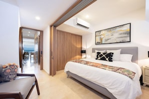 A modern hotel room with a large bed, a view of the sea, and a balcony. - Oceanfront Condo – 13th Floor | 8 Heated Pools | Rooftop Gym | 500 Mbps WiFi (Puerto Vallarta)