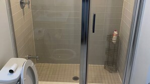 A modern bathroom with a glass-enclosed shower, a toilet, and a marble-tiled floor. - 2 bedroom 2 bathroom condominium downtown Toronto (Toronto)